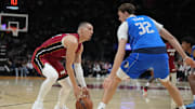 Nov 24, 2025; Miami, Florida, USA; Dallas Mavericks forward Cooper Flagg (32) defends Miami Heat guard Tyler Herro (14) during the first half at Kaseya Center. Mandatory Credit: Jim Rassol-Imagn Images