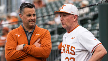 Texas Basketball coach Sean Miller chats with Texas Baseball coach Jim Schlossnagle as the Longhorns prepare to take on the Auburn Tigers in the first game of a three-game series on Thursday night at UFCU Disch-Falk Field in Austin, April 17, 2025.