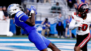 Middle Tennessee wide receiver Omari Kelly (1) catches a pass as Western Kentucky defensive back Jaymar Mundy (10) looks on during the rivalry football game at MTSU, on Saturday, Sept. 14, 2024.