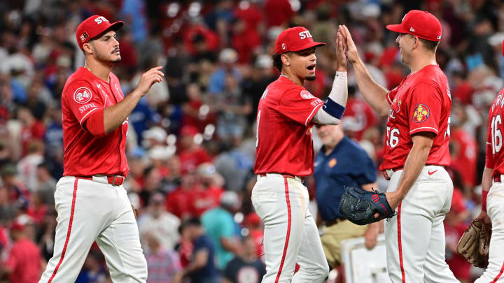 Aug 17, 2024; St. Louis, Missouri, USA;  St. Louis Cardinals third base Nolan Arenado (28) and shortstop Masyn Winn (0) greet St. Louis Cardinals pitcher Ryan Helsley (56, right) after Helsley pitched in relief in the ninth inning against the Los Angeles Dodgers at Busch Stadium. Mandatory Credit: Tim Vizer-USA TODAY Sports