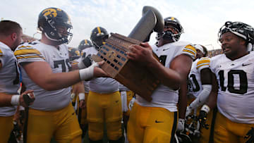 Iowa Football team celebrates with Cy-Hawk trophy after winning 20-13 over Iowa State at the Jack Trice Stadium on Saturday, Sept. 9, 2023, in Ames, Iowa.