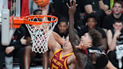 Iowa State Cyclones forward Brandton Chatfield (33) goes for a layup as Cincinnati Bearcats' forward Dillon Mitchell (23) and forward Aziz Bandaogo (55) defend during the first half in the Big-12 men’s basketball at Hilton Coliseum on Feb. 15, 2025 in Ames, Iowa.