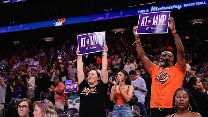 Fans hold up ÒAT for MVPÓ signs court side at a Mercury home game against the Chicago Sky at PHX Arena on Aug. 28, 2025, in Phoenix.