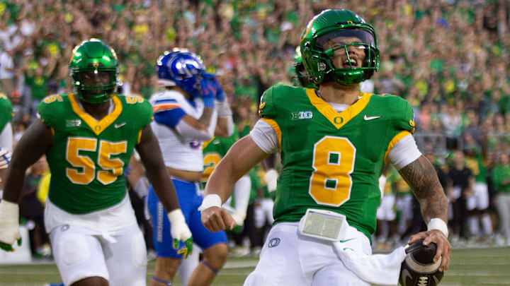 Oregon quarterback Dillon Gabriel, right, celebrates a first quarter touchdown against Boise State at Autzen Stadium in Eugene Sept. 7, 2024.