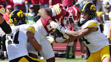 Iowa State Cyclones' running back Abu Sama III (24) battle for a few yard as getting tackle by Iowa Hawkeyes linebacker Jaden Harrell (41) and defensive back Koen Entringer (4) during the second quarter in the Cy-Hawk Series at Jack Trice Stadium on Sept. 6, 2025, in Ames, Iowa