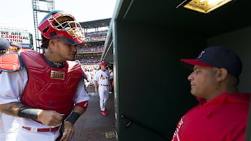 Apr 14, 2013; St. Louis, MO, USA; St. Louis Cardinals catcher Yadier Molina (4) talks with his brother Cardinals assistant hitting coach Bengie Molina (18) before the game against the Milwaukee Brewers at Busch Stadium. The Brewers defeated the Cardinals 4-3. 