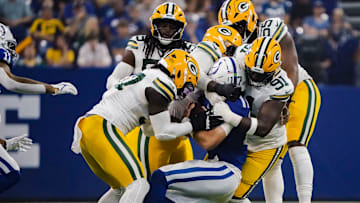Indianapolis Colts quarterback Daniel Jones (17) is tackled by 5 Green Bay Packers on Saturday, Aug. 16, 2025, during a game against the Green Bay Packers at Lucas Oil Stadium in Indianapolis.