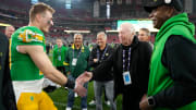 Oregon Ducks quarterback Bo Nix greets Phil Knight after defeating the Liberty Flames to win the Fiesta Bowl at State Farm Stadium in Glendale on Jan. 1, 2024.