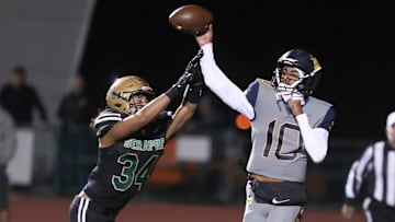 Warren quarterback Madden Iamaleava is under pressure by St. Bonaventure's Jacob Moraga as he fires a pass during the first quarter of the Seraphs' 24-21 win in the CIF-SS Division 3 championship game.