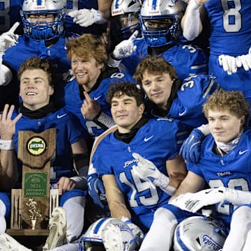 The Olentangy Liberty football team poses with the Division I state championship trophy after defeating Moeller 28-14 on Friday, Dec. 6, 2024.