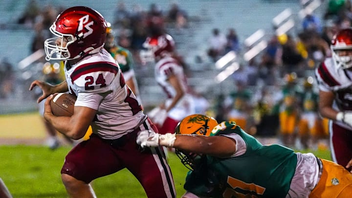 Palm Springs' running back darts away from a would-be tackle against Coachella Valley during the fourth quarter of their game at Coachella Valley High School in Thermal, Calif., Friday, Sept. 5, 2025. Palm Springs' running back darts away from a would-be tackle against Coachella Valley during the fourth quarter of their game at Coachella Valley High School in Thermal, Calif., Friday, Sept. 5, 2025.