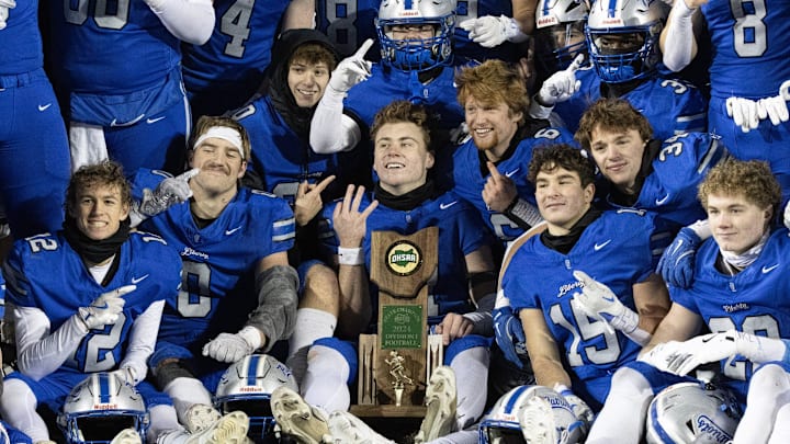 The Olentangy Liberty football team poses with the Division I state championship trophy after defeating Moeller 28-14 on Friday, Dec. 6, 2024. The Olentangy Liberty football team poses with the Division I state championship trophy after defeating Moeller 28-14 on Friday, Dec. 6, 2024.
