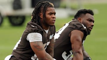 Cleveland Browns running backs Quinshon Judkins, left, and Jerome Ford rest on the sideline during a practice at the team's training facility May 28, 2025, in Berea, Ohio.
