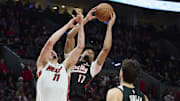 Jan 11, 2025; Portland, Oregon, USA: Portland Trail Blazers guard Shaedon Sharpe (17) grabs a rebound during the second half against Miami Heat guard Jaime Jaquez Jr. (11) at Moda Center. Mandatory Credit: Troy Wayrynen-Imagn Images
