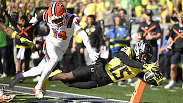 Oct 26, 2024; Eugene, Oregon, USA; Oregon Ducks wide receiver Tez Johnson (15) scores a touchdown during the first half against Illinois Fighting Illini defensive back Xavier Scott (14) at Autzen Stadium.