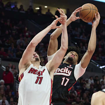 Jan 11, 2025; Portland, Oregon, USA: Portland Trail Blazers guard Shaedon Sharpe (17) grabs a rebound during the second half against Miami Heat guard Jaime Jaquez Jr. (11) at Moda Center. Mandatory Credit: Troy Wayrynen-Imagn Images