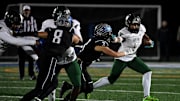 Decatur's Gavin Solito (3) tackles Milford Mill's Damon Ferguson (5) Friday, Nov. 24, 2023, in the 2A State Semifinal in Berlin, Maryland. Decatur defeated Milford Mill 35-34.