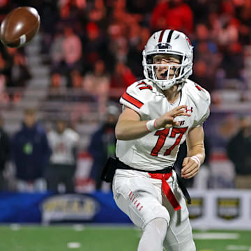 Peters Township quarterback Nolan DiLuca flips the ball to his running back during the 2023 PIAA Class 5A state championship game. 