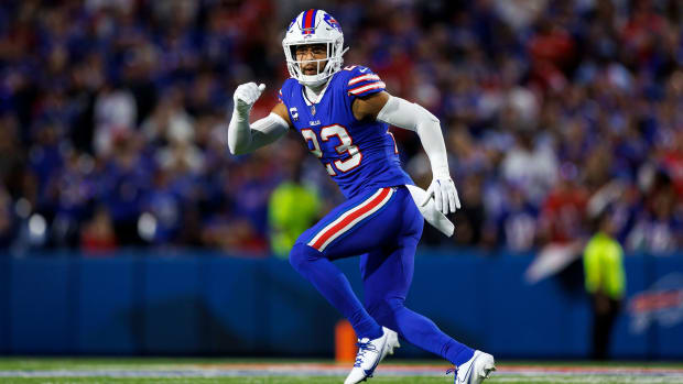 Buffalo Bills safety Micah Hyde (all-blue jersey with white sleeves and helmet) plays defense during a football game. 