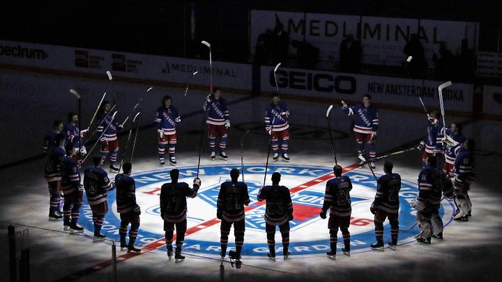 Jan 14, 2021; New York, NY, USA;  New York Rangers players huddle around the center ice logo as they prepare for the home opener against the New York Islanders at Madison Square Garden.  Mandatory Credit: Bruce Bennett/Pool Photo via Imagn Images
