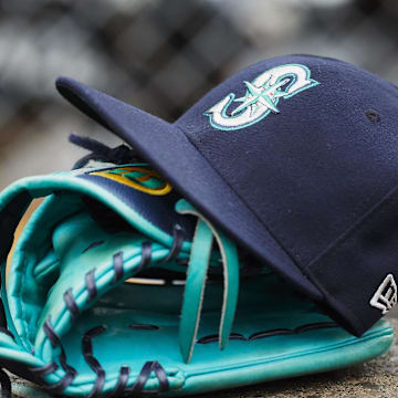 Hat and glove of Seattle Mariners center fielder Dee Gordon (9) sits in dugout during the third inning against the Detroit Tigers at Comerica Park in 2018.