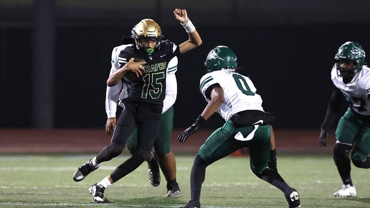 St. Bonaventure's quarterback Jaxson Carper tries to avoid Pacifica's Isaiah Phelps during the second quarter of the Marmonte League football game Friday night at Buena High School. St. Bonaventure won, 37-35.