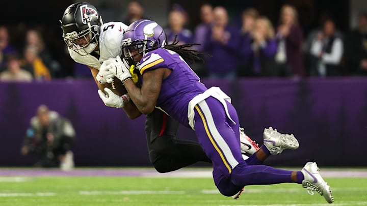 Atlanta Falcons wide receiver Drake London (5) catches a pass as Minnesota Vikings cornerback Shaquill Griffin (1) defends during the third quarter at U.S. Bank Stadium.