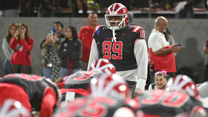 Mater Dei DL Semi Taulanga leads the Monarchs in pregame exercises before the Monarchs' 59-14 win over St. John Bosco. Next up is Orange Lutheran. 