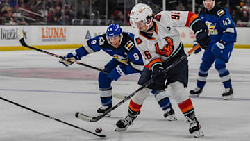 Coachella Valley forward Logan Morrison tries to break away for a shot only to be met by a Colorado Eagles defender during the first period of their game at Acrisure Arena in Palm Desert, Calif., Tuesday, Dec. 31, 2024.