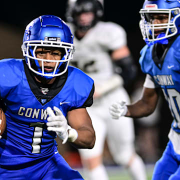 Trey Harris ran for more than 100 yards Friday night in Conway's win over Bentonville.