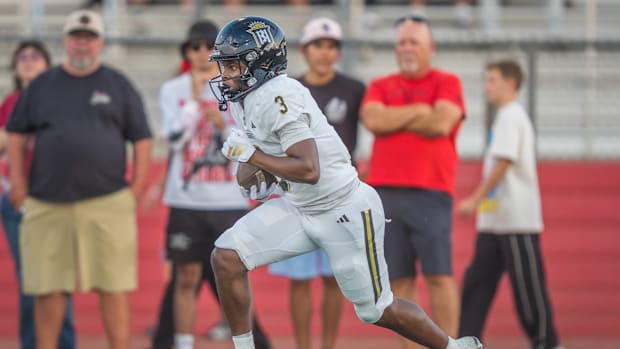 Servite wide receiver Benjamin Harris sprints upfield on a kick return during a high school football game.