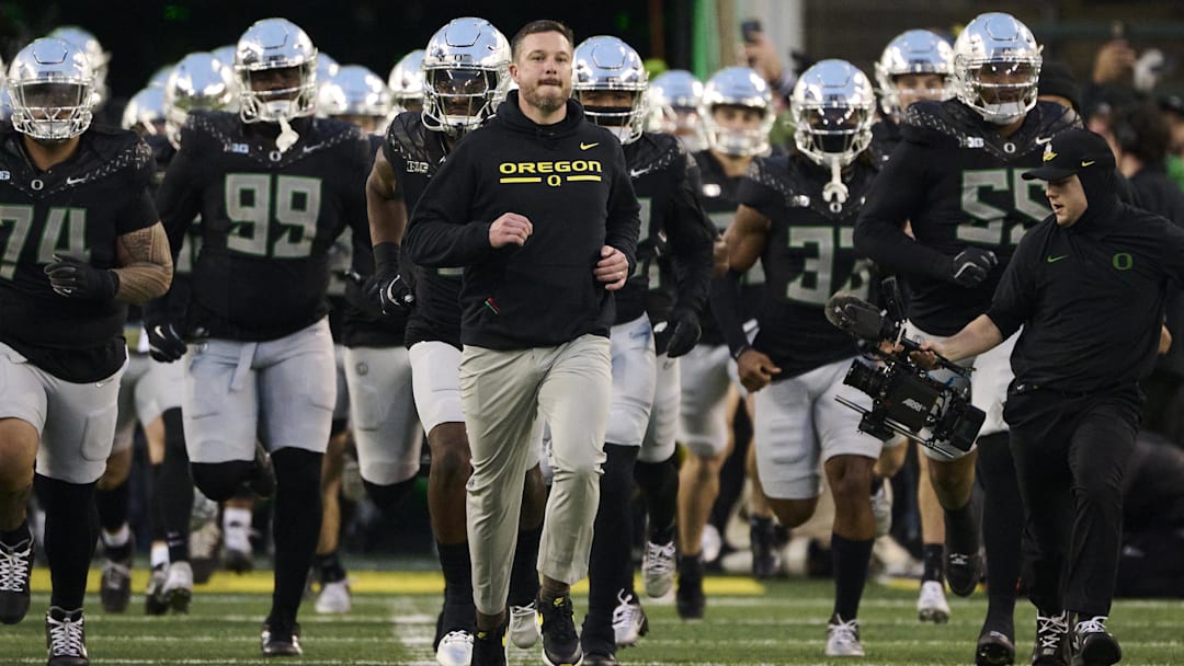 Nov 30, 2024; Eugene, Oregon, USA; Oregon Ducks head coach Dan Lanning runs out with the team before a game against the Washington Huskies at Autzen Stadium. Nov 30, 2024; Eugene, Oregon, USA; Oregon Ducks head coach Dan Lanning runs out with the team before a game against the Washington Huskies at Autzen Stadium.