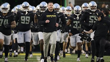 Nov 30, 2024; Eugene, Oregon, USA; Oregon Ducks head coach Dan Lanning runs out with the team before a game against the Washington Huskies at Autzen Stadium.