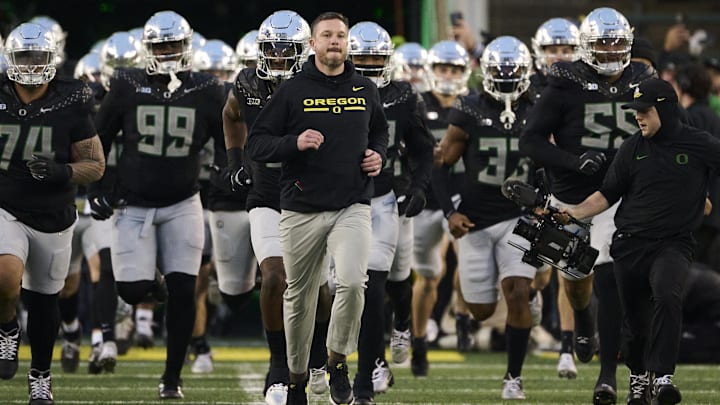 Nov 30, 2024; Eugene, Oregon, USA; Oregon Ducks head coach Dan Lanning runs out with the team before a game against the Washington Huskies at Autzen Stadium.