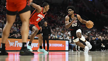 Apr 12, 2024; Portland, Oregon, USA; Portland Trail Blazers guard Scoot Henderson (00) drives to the basket during the second half against Houston Rockets forward Jabari Smith Jr. (10) at Moda Center. Mandatory Credit: Troy Wayrynen-Imagn Images