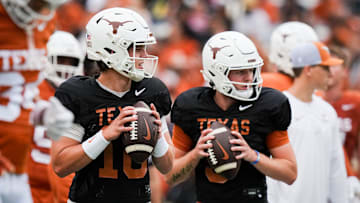 Texas Longhorns quarterbacks Arch Manning (16), left, and Quinn Ewers (3) throw passes while warming up ahead of the Longhorns' spring Orange and White game at Darrell K Royal Texas Memorial Stadium in Austin, Texas, April 20, 2024.