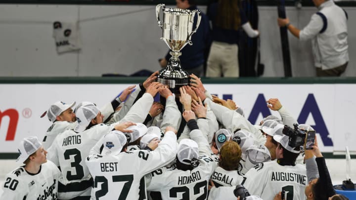 Members of the MSU Spartan hockey team celebrate the Spartan's Big Ten Championship