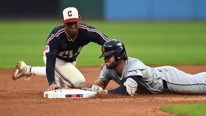 Jul 22, 2024; Cleveland, Ohio, USA; Detroit Tigers third baseman Matt Vierling (8) slides into second with a double as Cleveland Guardians shortstop Brayan Rocchio (4) is late with the tag during the seventh inning at Progressive Field. Mandatory Credit: Ken Blaze-USA TODAY Sports