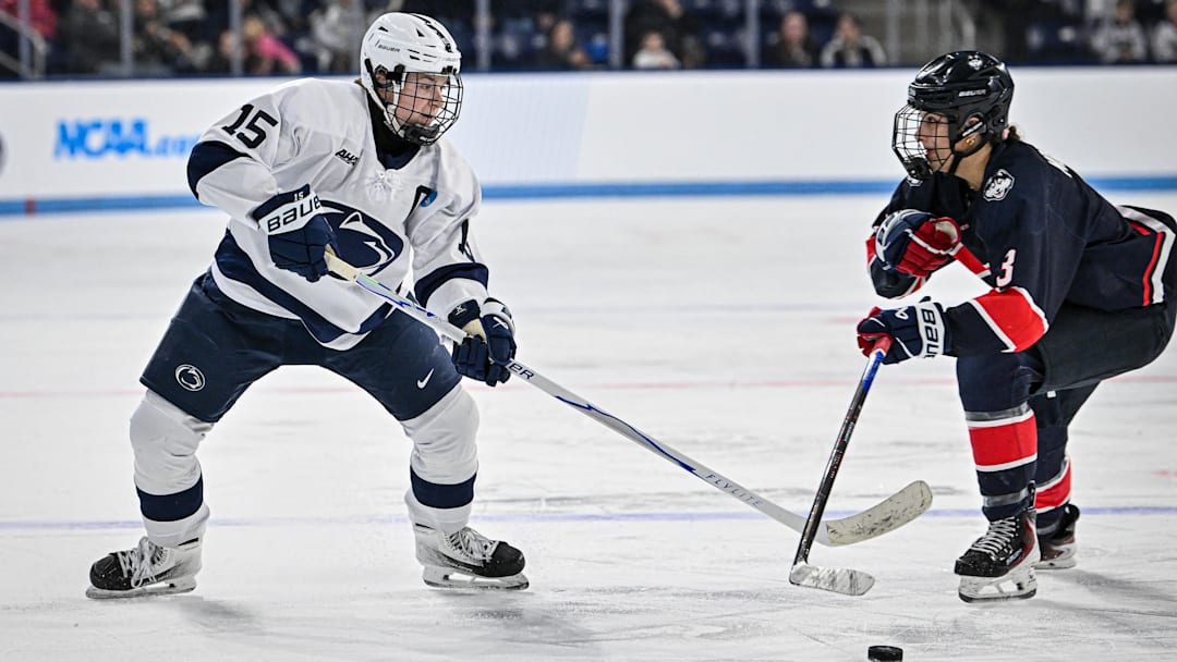 Penn State hockey player Tessa Janecke goes for the puck during a Nittany Lions hockey game.