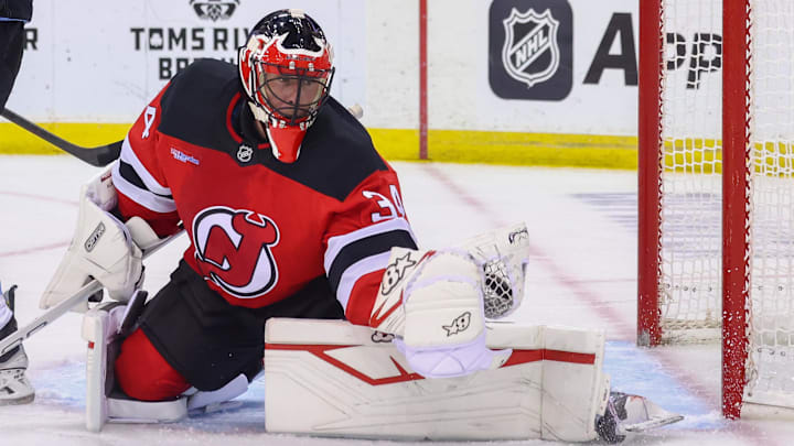 New Jersey Devils goaltender Jake Allen (34) makes a save against the Utah Hockey Club. Mandatory Credit: Ed Mulholland-Imagn Images