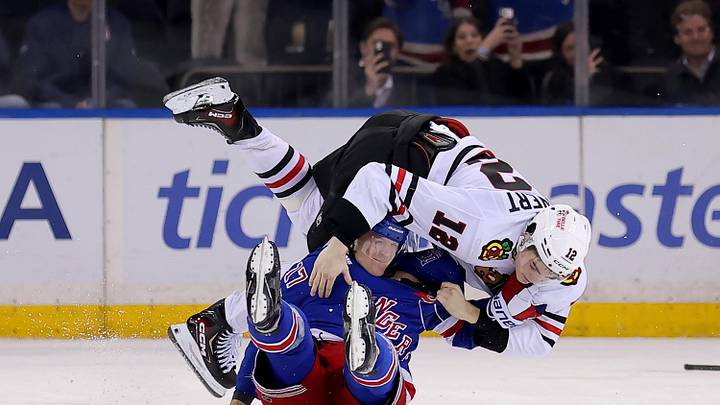 Mar 27, 2026; New York, New York, USA; Chicago Blackhawks center Sacha Boisvert (12) fights with New York Rangers defenseman Will Borgen (17) during the third period at Madison Square Garden. Mandatory Credit: Brad Penner-Imagn Images