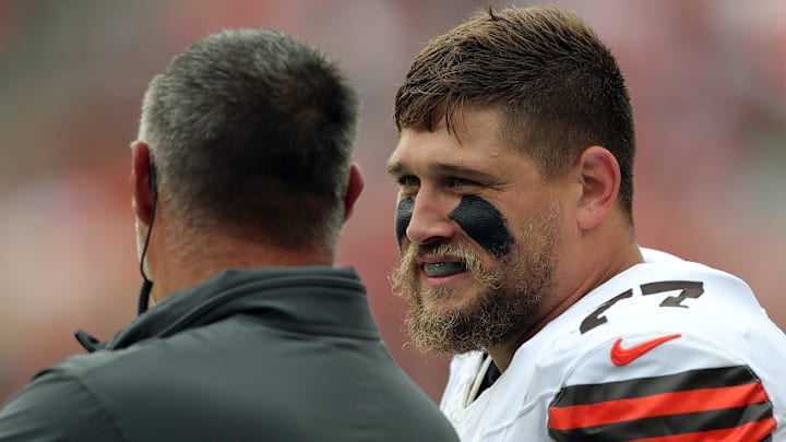 Cleveland Browns guard Wyatt Teller (77) chats with senior consultant Mike Vrabel on the sideline during the first half of an NFL preseason football game at Cleveland Browns Stadium, Saturday, Aug. 10, 2024, in Cleveland, Ohio.