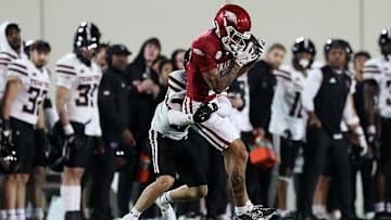 Arkansas Razorback receiver CJ Brown hauls in a catch against Texas Tech's Joseph Plunk during the 2024 AutoZone Liberty Bowl
