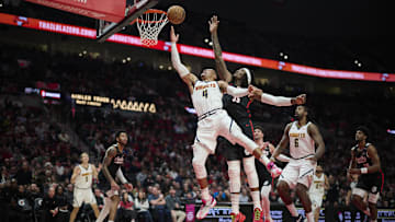 Dec 19, 2024; Portland, Oregon, USA; Denver Nuggets guard Russell Westbrook (4) drives to the basket during the second half against Portland Trail Blazers center Robert Williams III (35) at Moda Center. Mandatory Credit: Troy Wayrynen-Imagn Images