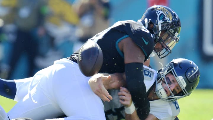 Jacksonville Jaguars linebacker Dawuane Smoot (91) forces the fumble on the sack of Tennessee Titans quarterback Will Levis (8) during first quarter action. The Jaguars recovered the ball. The Jacksonville Jaguars hosted the Tennessee Titans at EverBank Stadium in Jacksonville, FL Sunday, November 19, 2023. The Jaguars led 13 to 0 at the half. [Bob Self/Florida Times-Union]