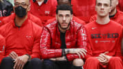 Apr 22, 2022; Chicago, Illinois, USA; Chicago Bulls guard Lonzo Ball (center) looks on from the bench.