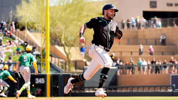 Arizona Diamondbacks Garrett Hampson scores on a Randal Grichuk single off Athletics starting pitcher Joey Estes in the second inning during a spring training game at Salt River Fields in Scottsdale on March 20, 2025.