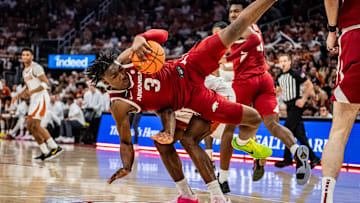 Arkansas Razorbacks forward Adou Thiero (3) tumbles over Texas Longhorns forward Ze'Rik Onyema (21) after catching the rebound in the first half as the Longhorns take on the Razorbacks at the Moody Center, Feb. 5, 2025.