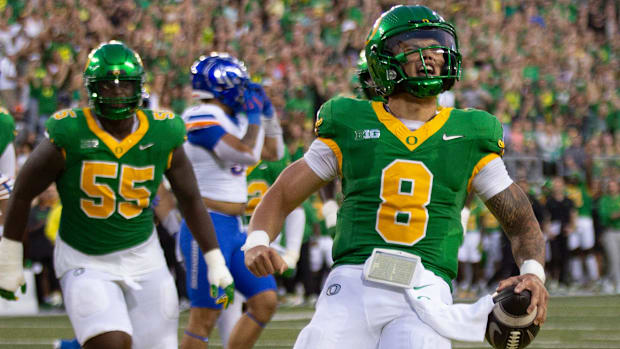 Oregon quarterback Dillon Gabriel, right, celebrates a first quarter touchdown against Boise State