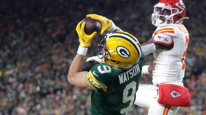 Green Bay Packers wide receiver Christian Watson (9) catches a touchdown pass in front of Kansas City Chiefs cornerback Joshua Williams on Dec. 3 at Lambeau Field.